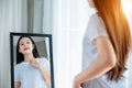 Asian teenage woman looking her body shape on a mirror Royalty Free Stock Photo