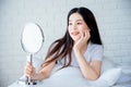 Asian teenage woman looking at mirror Royalty Free Stock Photo