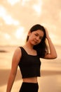 An Asian teenager with a cute face in black clothes smiles while enjoying the beautiful scenery on the beach Royalty Free Stock Photo