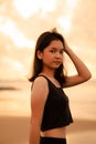 An Asian teenager with a cute face in black clothes smiles while enjoying the beautiful scenery on the beach Royalty Free Stock Photo