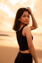 An Asian teenager with a cute face in black clothes smiles while enjoying the beautiful scenery on the beach Royalty Free Stock Photo