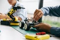 Asian teenager doing robot project in science classroom