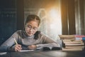 Asian teenager doing school home work in library room