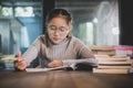 Asian teenager doing school home work in library room