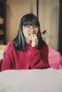 Asian teenager eating cream cracker at home dinning room Royalty Free Stock Photo