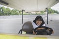 Asian teenager funny driving on golf car