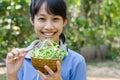 Asian Teenager Girl Happy with The Vegetable Sunflower Sprouts. Royalty Free Stock Photo