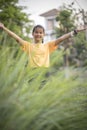 Asian teenager hand sign victory in green garden