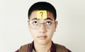 Asian teenager and post it note on his face, education and the final exam concept