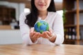 Asian teenager showing earth plasticine on hands, ecology and environment sustainable in global warming crisis during, net zero