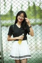 Asian teenager smiling face holding pastic bottle in hand Royalty Free Stock Photo