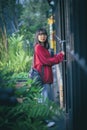 Asian teenager standing against close door