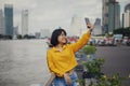 Asian teenager taking selfie portrait at bangkok city street