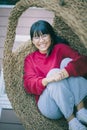 Asian teenager toothy smiling with happiness face ,relaxing on bamboo cradle Royalty Free Stock Photo