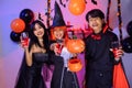 Asian Teenagers in Halloween Costumes Looking Camera, Invite For Enchanting Halloween Season Celebrations. Halloween Haunt Party