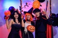 Asian Teenagers in Halloween Costumes Looking Camera, Invite For Enchanting Halloween Season Celebrations. Halloween Haunt Party