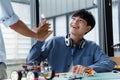 Asian teenagers hive five with friend in robotic laboratory