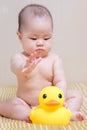 Asian thai baby girl playing with yellow duck Royalty Free Stock Photo