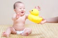 Asian thai baby girl playing with yellow duck Royalty Free Stock Photo