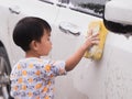 Asian Thai cute kid washing car