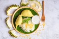 Asian Thai dessert tropical sweet durian peel with yellow bean on wooden plate and fresh mint leaves, Ripe durian rice cooked with