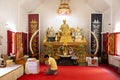 Asian thai man sitting respect praying with monks and buddha statue at Wat Phra That Doi Tung in Chiang Rai, Thailand Royalty Free Stock Photo