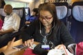 Asian thai old woman playing moblie phone and listen music while sit on train