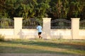 Asian thai people running jogging and exercise in dusk time at public garden park in Nonthaburi, Thailand.