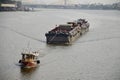 Thai people sailing barge and tugboat cargo ship in Chao Phraya river from Bangkok go to Ayutthaya in Nonthaburi, Thailand