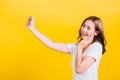 Woman teen smiling standing wear t-shirt making selfie photo, video call on smartphone Royalty Free Stock Photo