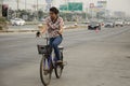 Asian thai woman biking bicycle on street highway with traffic r