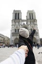 Asian thai woman lead someone by the hand and hold at Cathedrale Notre-Dame de Paris