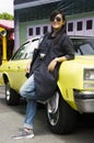Asian thai woman travel and posing with retro yellow classic car Royalty Free Stock Photo