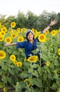 Asian thai woman travel and posing for take photo at sunflower field Royalty Free Stock Photo