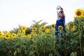 Asian thai woman travel and posing for take photo at sunflower field Royalty Free Stock Photo