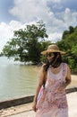 Asian thai woman traveling and posing at harbour with sea and sk Royalty Free Stock Photo