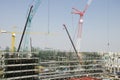 Asian thai workers and heavy machinery working builder new building at construction site high-rise building in Bangkok, Thailand. Royalty Free Stock Photo