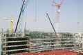 Asian thai workers and heavy machinery working builder new building at construction site high-rise building in Bangkok, Thailand. Royalty Free Stock Photo