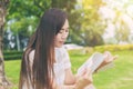 Asian thin teen relax reading in the green park