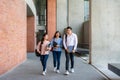 Asian three students are walking and talking together in university hall during break in University. Education, Learning, Student Royalty Free Stock Photo