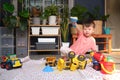 Asian  toddler boy playing with kinetic sand at home, Child playing with toy construction machinery, Montessori education, Royalty Free Stock Photo