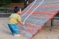 asian toddler boy playing in outdoor playground Royalty Free Stock Photo