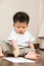 Asian toddler busy drawing