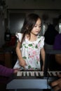 Asian toddler children young kids playing keyboard piano at home Royalty Free Stock Photo