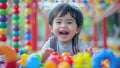 Asian toddler enjoying colorful playground toys Royalty Free Stock Photo