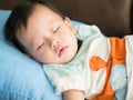 Asian toddler fell into a slumber on bed. Royalty Free Stock Photo