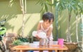 Asian toddler girl having fun pouring water into cup, Wet Pouring Montessori Preschool Practical Life Activities, Fine Motor