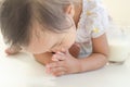 Asian toddler girl prostrate herself to elder for thanks