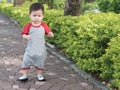 Asian toddler walk in park outdoor morning summer.
