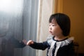 Asian toddler watching the snow